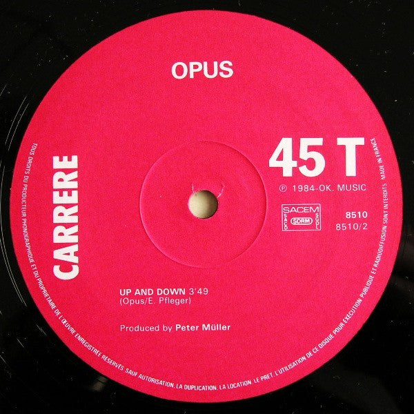 Opus - 1984 French Vinyl 12 - Inch 45 RPM Maxi - Single Pop Rock Record - Live Is Life / Up And Down (VG+ Condition) by Carrere Label